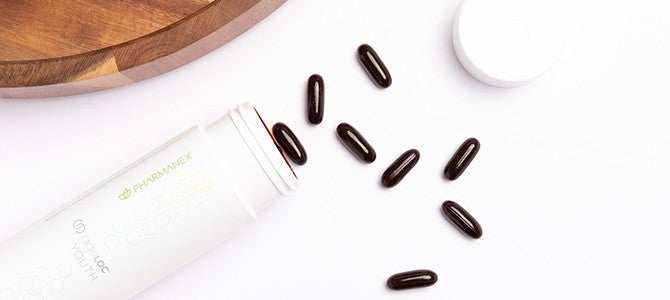 ageLOC youth study - image 02 bottle of ageLOC youth poured out on a table