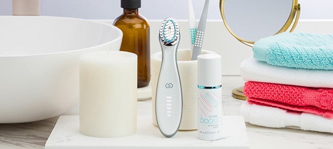 nu skin device article - boost - In-Article Image nu skin skin care device ageloc boost and serum on bathroom counter